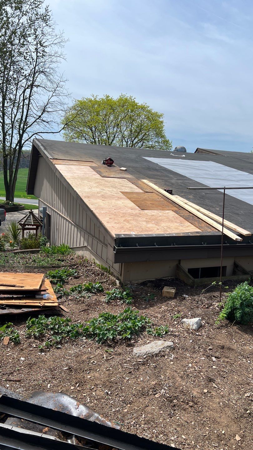 Flat roof replacement in progress with new roof decking installed on Old Mill Road.