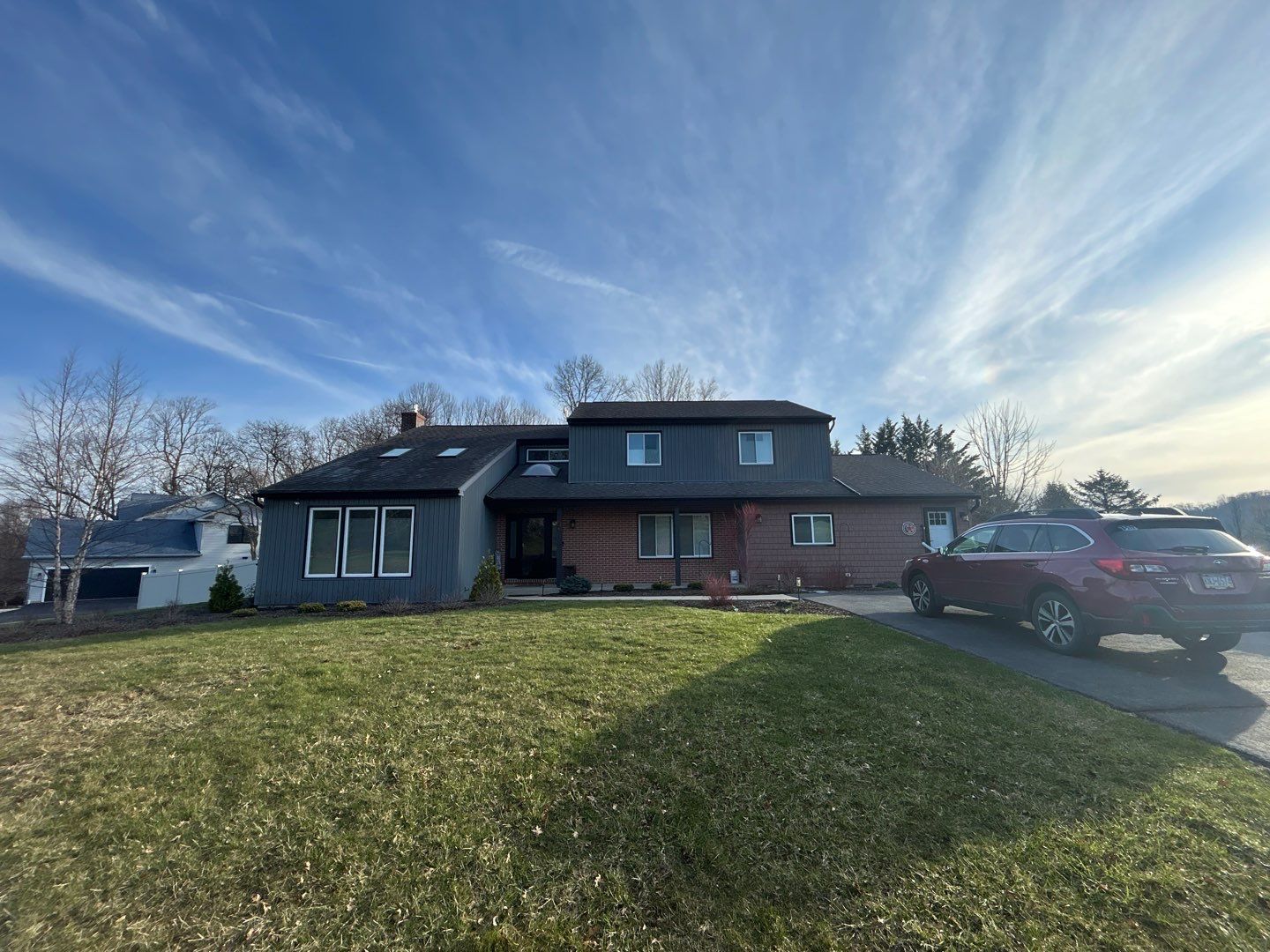 Completed asphalt shingle roof replacement on a residential home on Forest View Drive by Joyland Roofing.