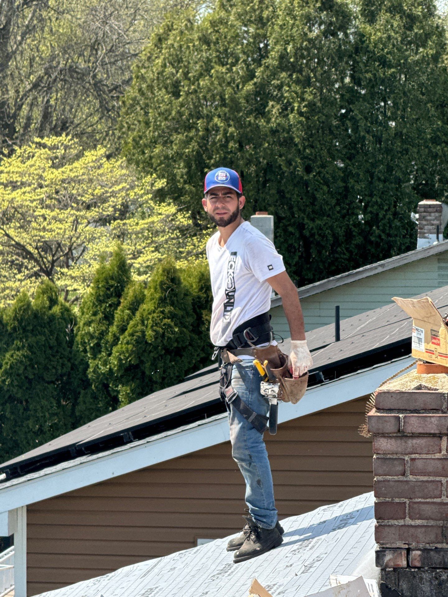 Roofing contractor installing a new roofing system during a roof replacement project on Golf Road in Myerstown, PA.