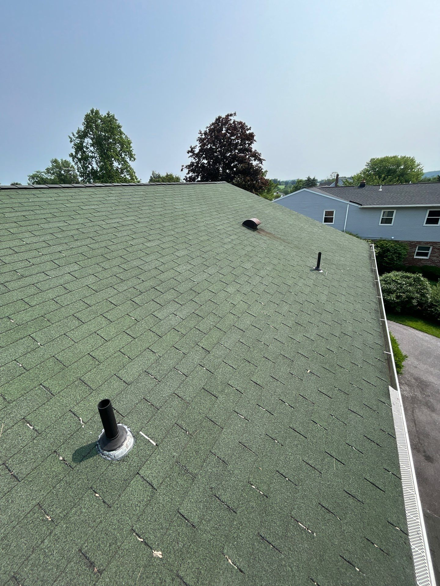 Green asphalt shingle roof inspected by Joyland Roofing on a home in Skyview Drive, Shrewsbury, PA.