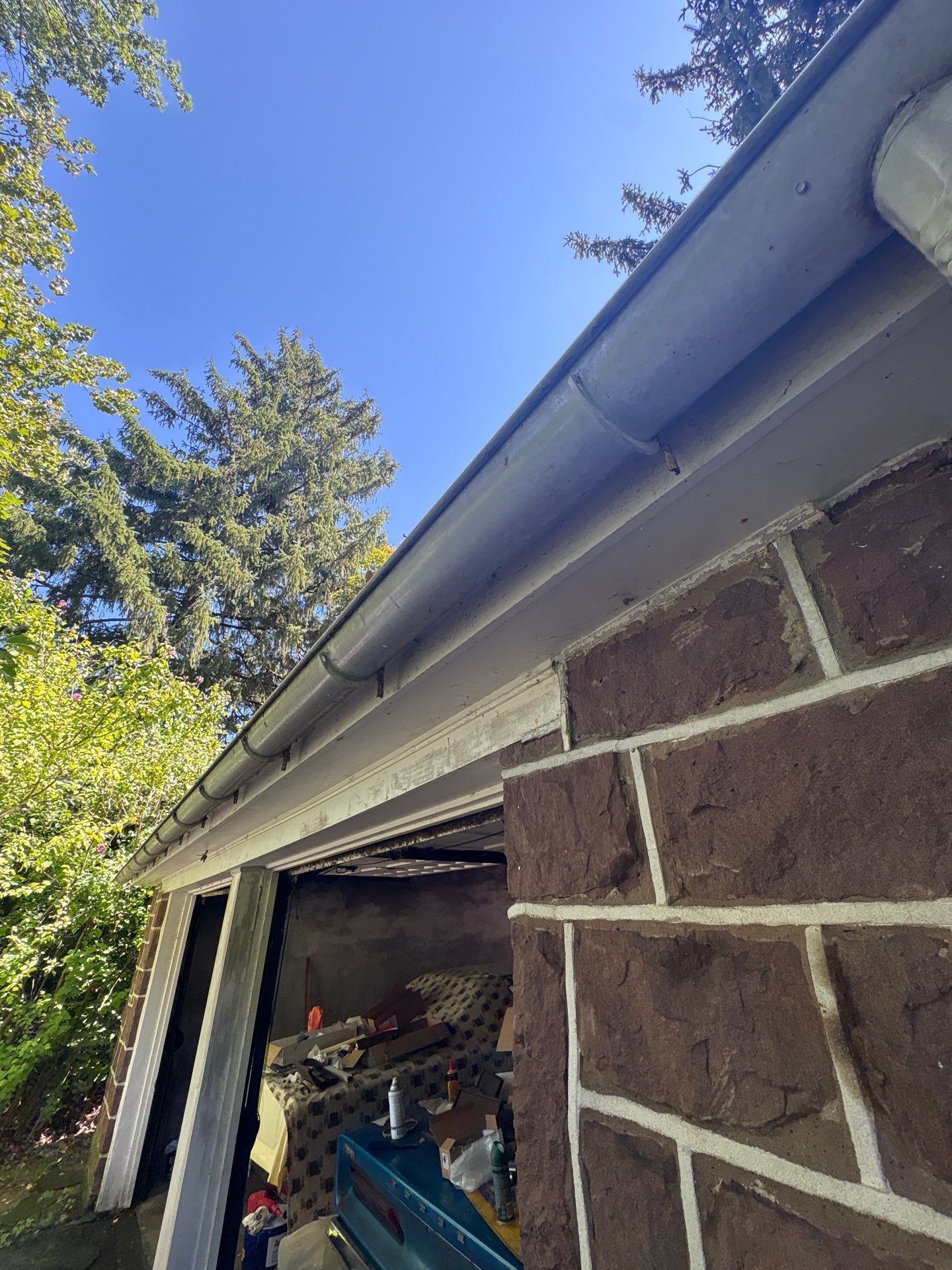 Residential gutter and downspout system along a brick home in Fort Washington, PA