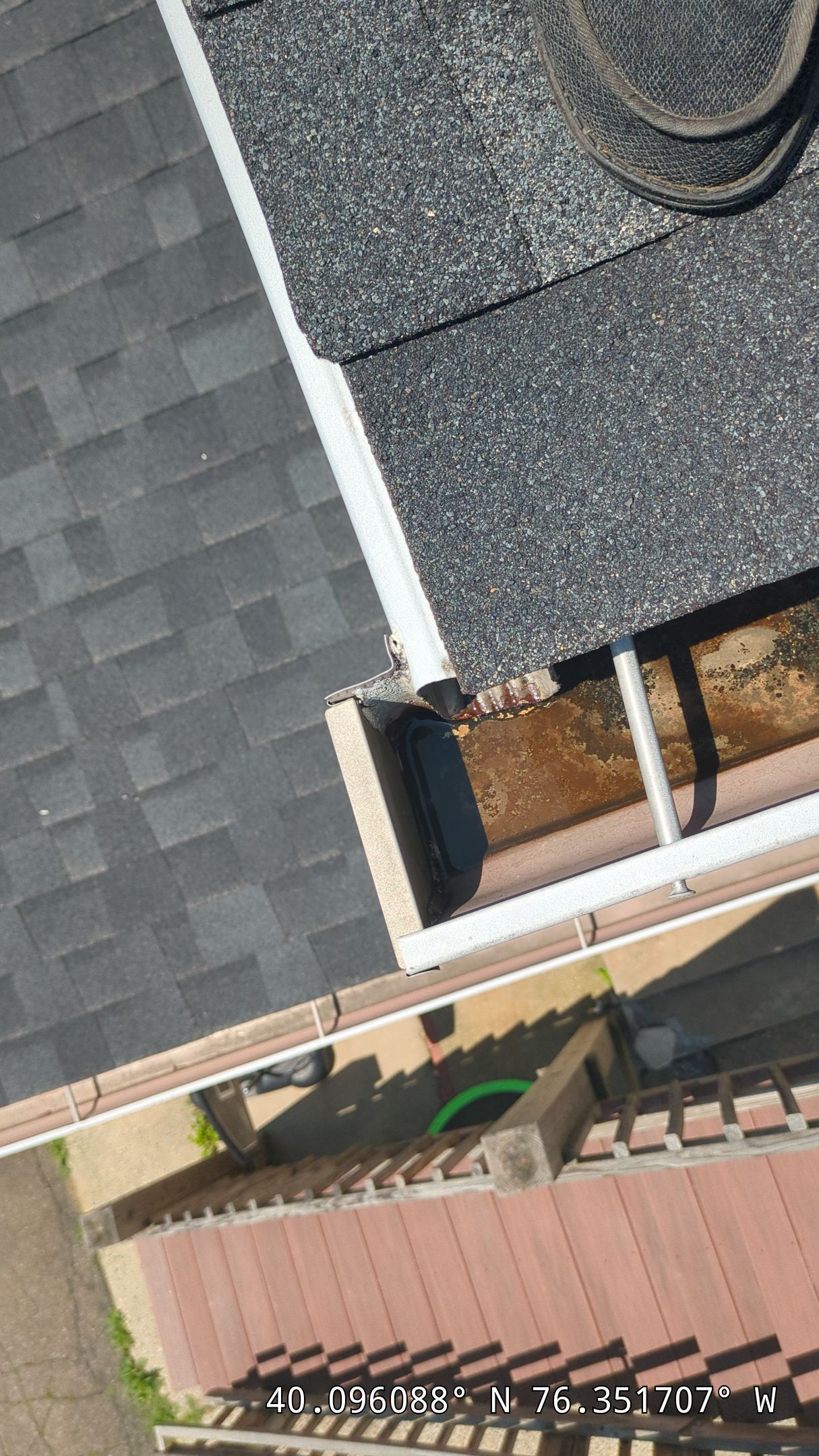 Roof and gutter corner repair on Main Street in East Petersburg, PA showing deteriorated gutter end cap, fascia edge, and water drainage concerns requiring professional roofing service.