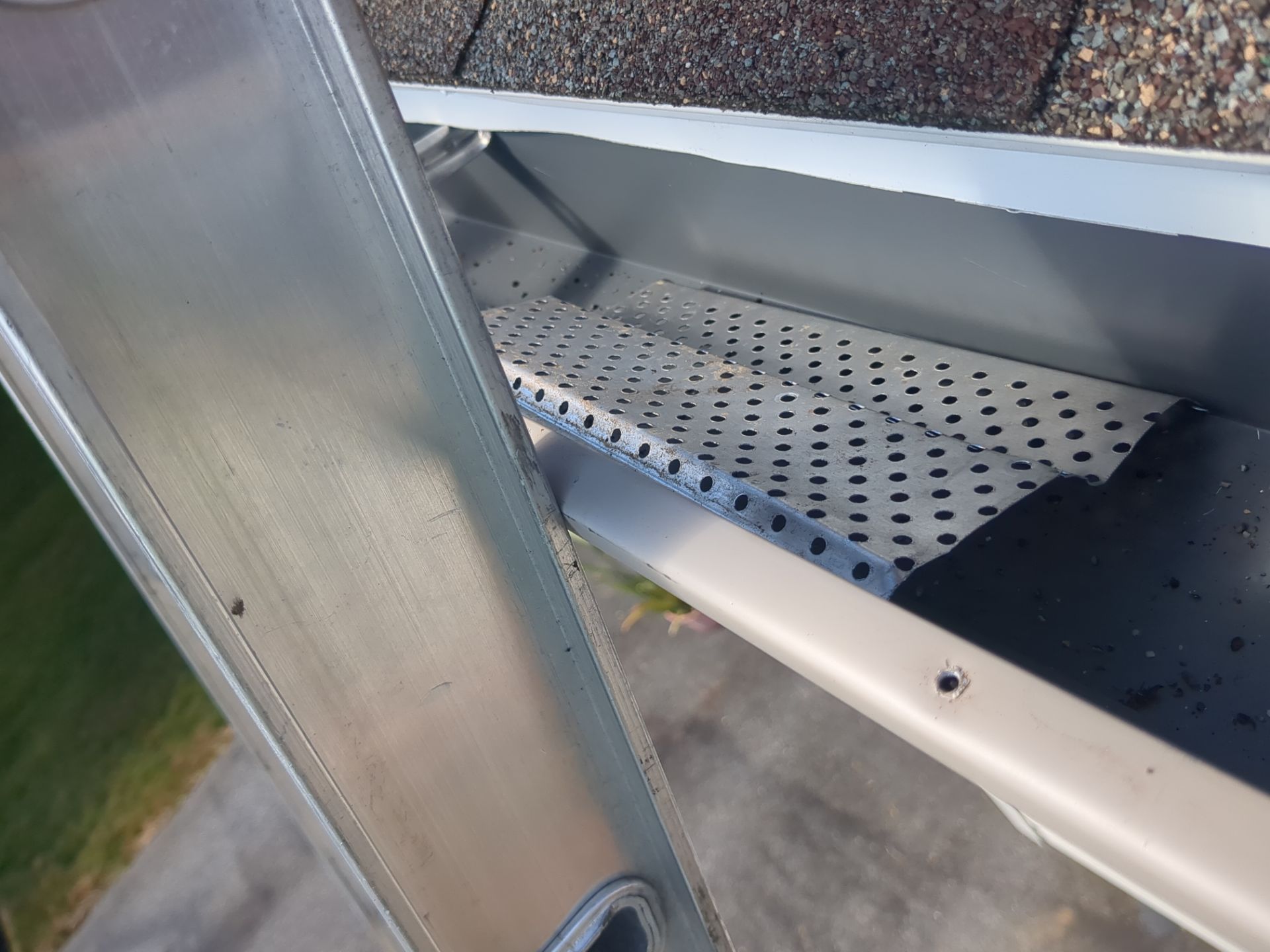 Gutter guard repair and drainage system inspection on Maytown Road in Elizabethtown, PA showing perforated leaf protection installed inside a residential gutter system.