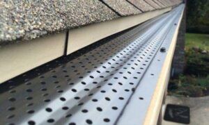 Overhead view of a house roof with a gray and dark blue metal finish.