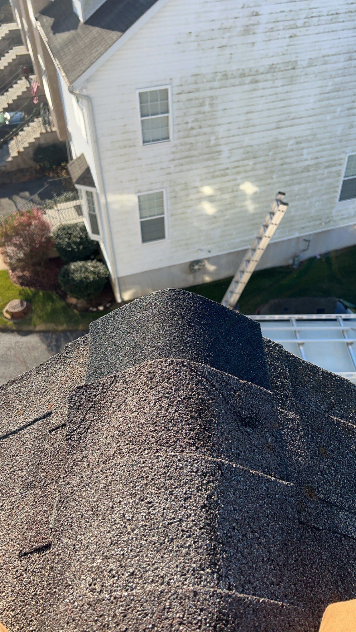 Close-up of asphalt shingle ridge cap inspected during a residential roof maintenance service on Hampton Court in Morgantown, PA