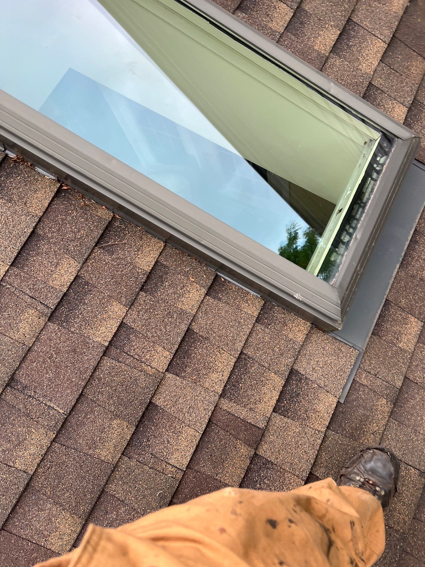 Professional skylight flashing repair on an asphalt shingle roof completed by Joyland Roofing on Harwood Lane.