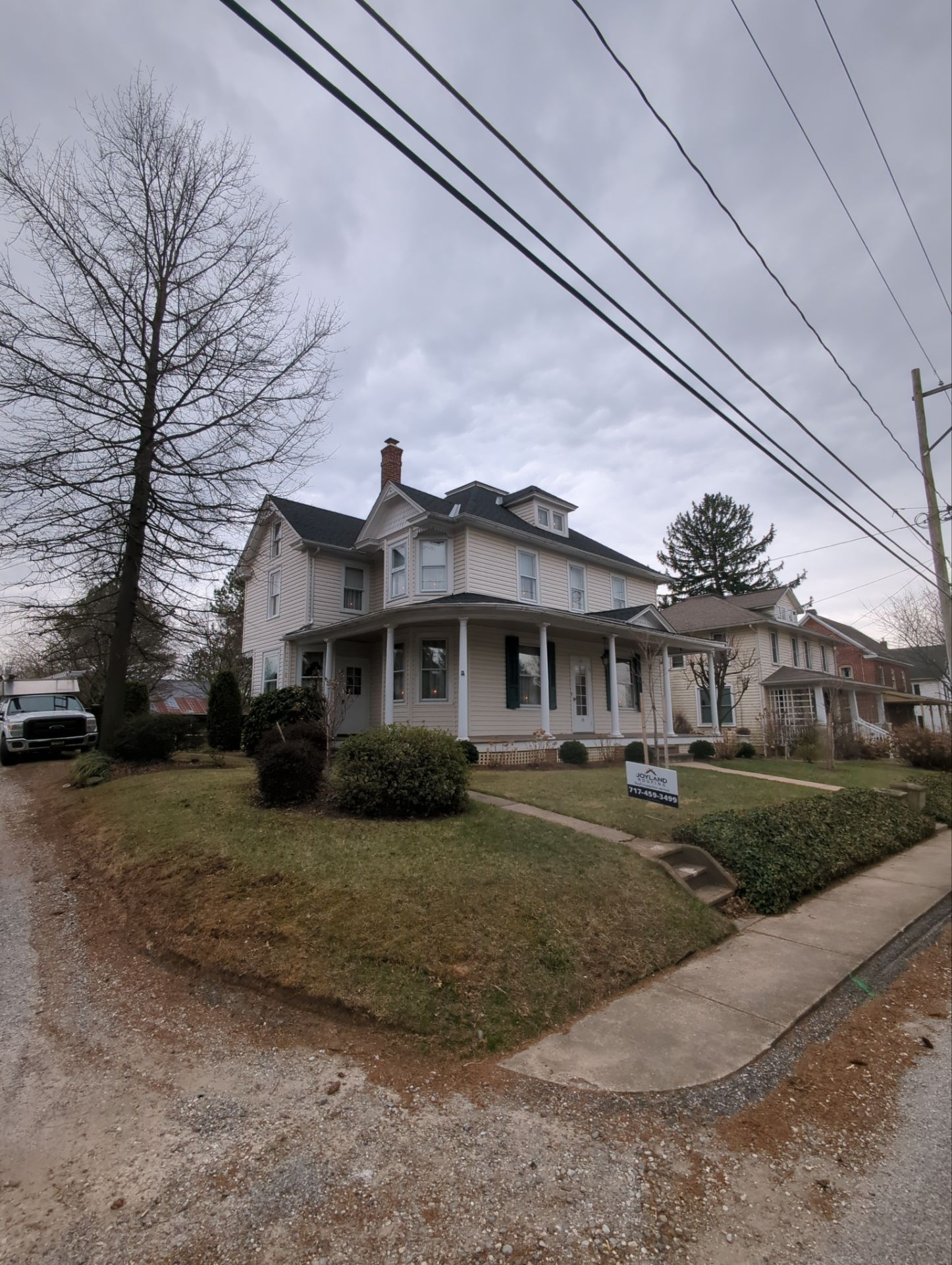 Historic two-story home on Mill Street in Stewartstown, PA, prepared for a residential roof replacement to improve long-term weather protection.