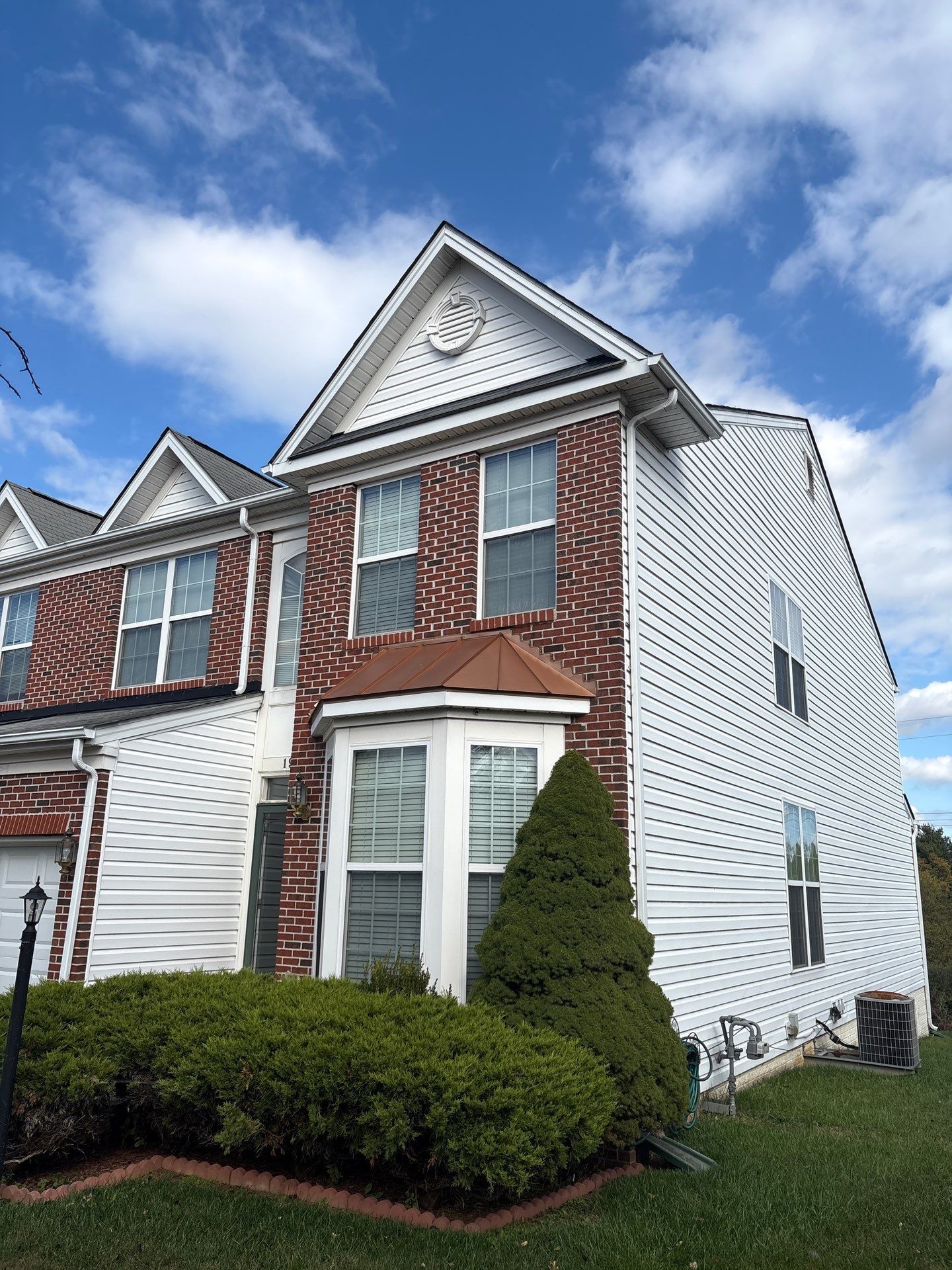 Townhome exterior in York, PA featuring a completed residential roofing installation by Joyland Roofing with upgraded shingles and clean curb appeal.