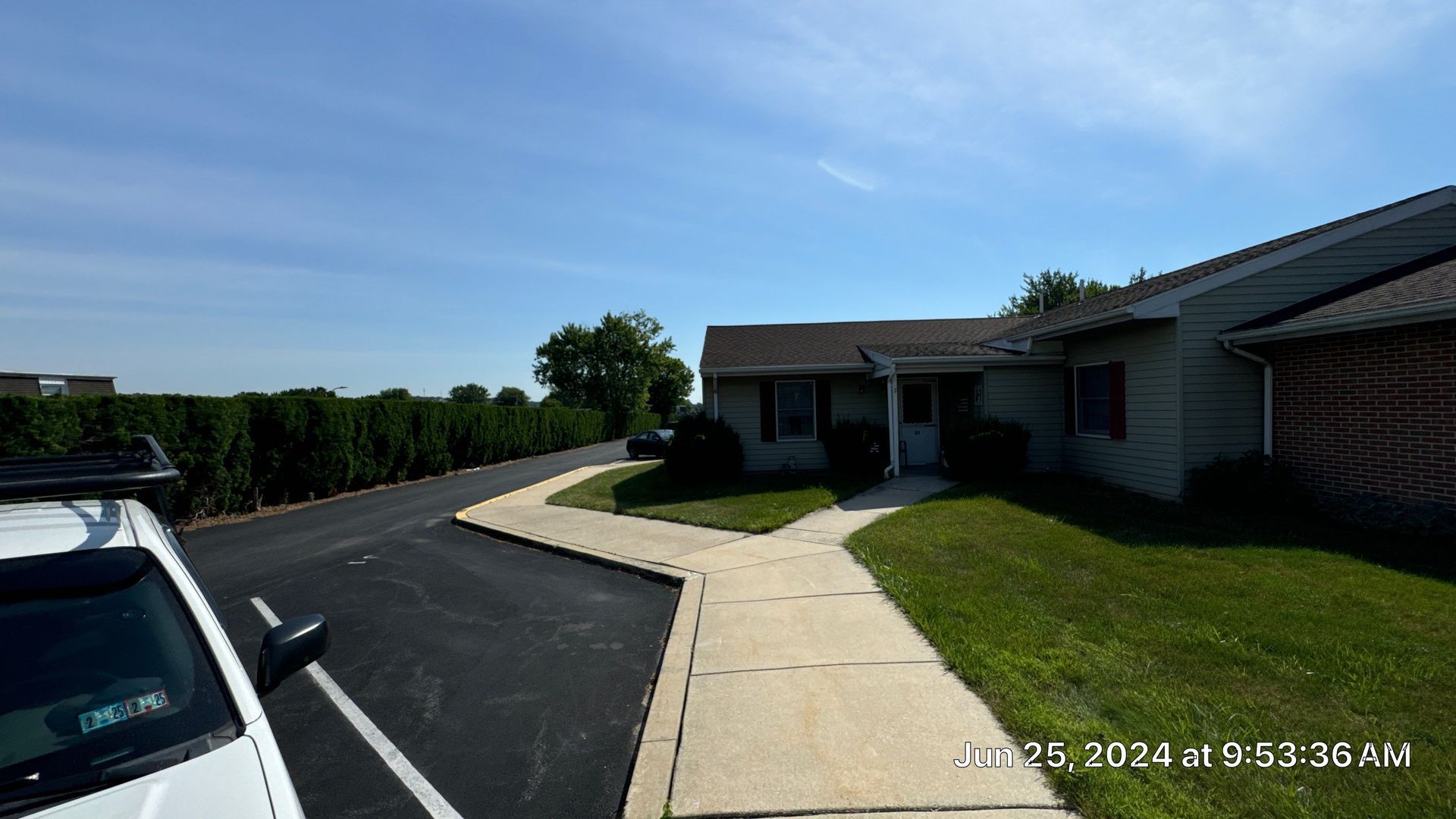 K Building with asphalt shingle roofing, vinyl siding, brick exterior, sidewalks, and landscaped grounds in Kutztown, PA.