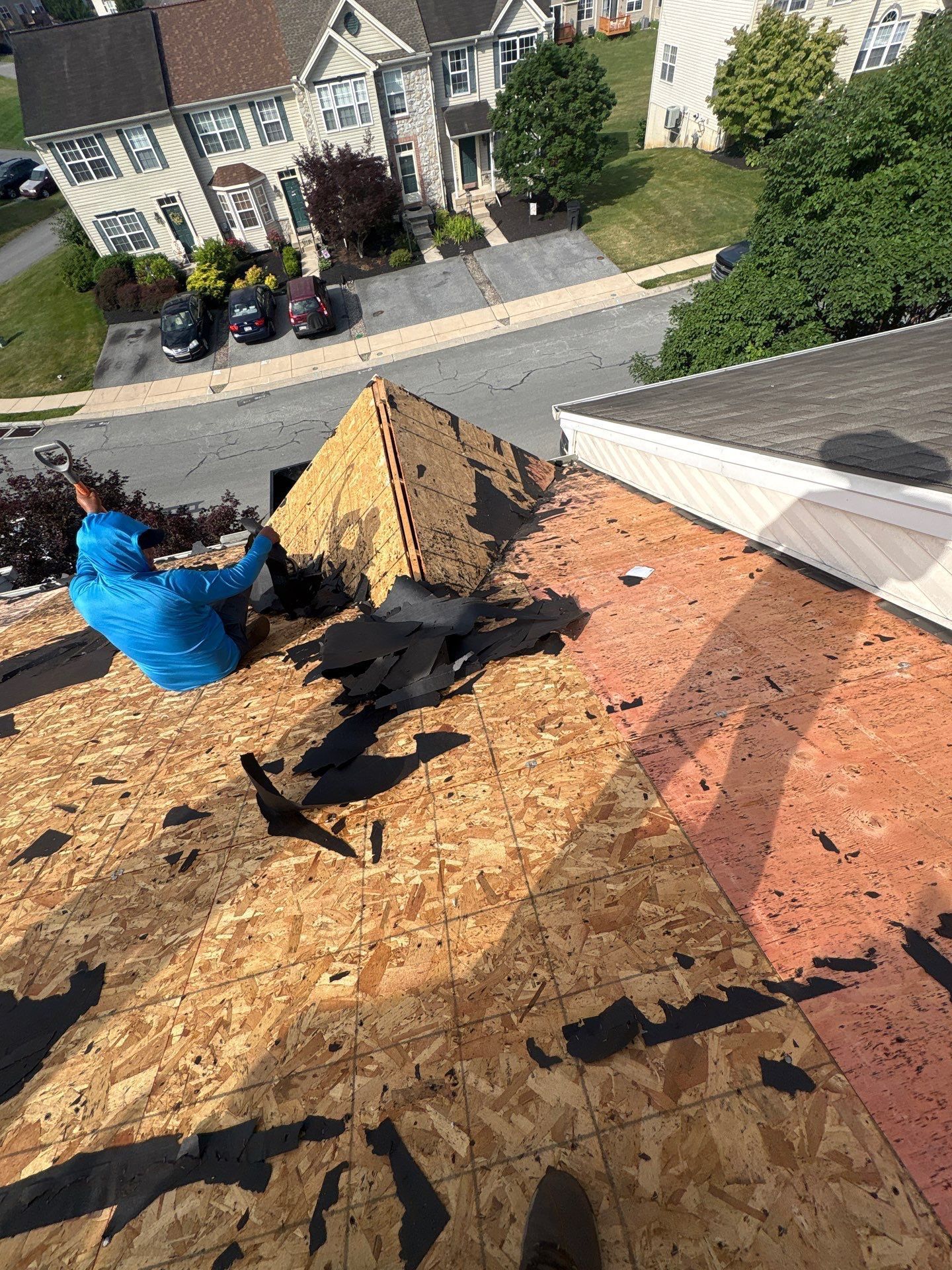 Roof replacement underway on Knollwood Road in Millersville, PA with old shingles removed and new roof decking exposed.