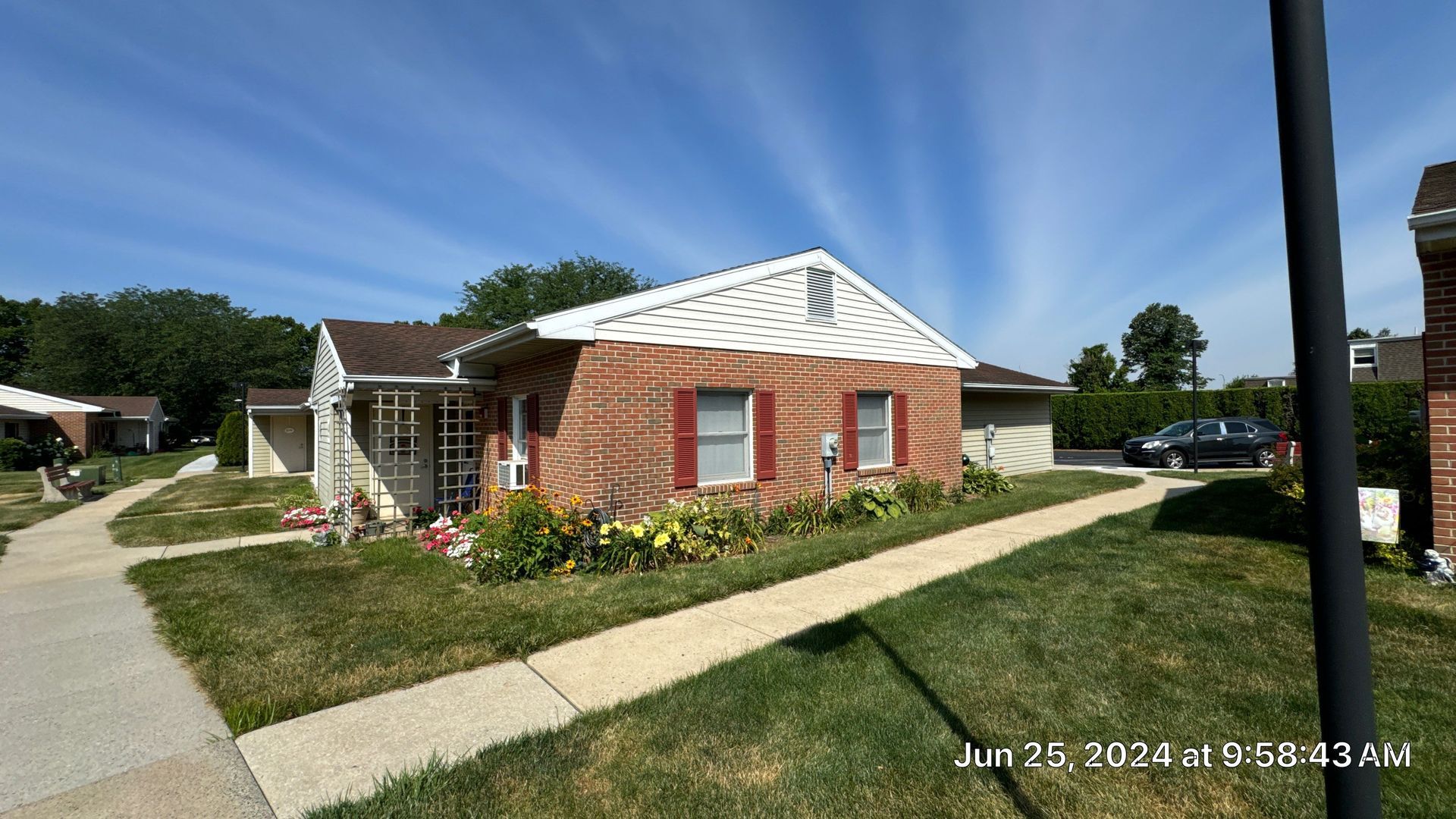 L Building exterior with asphalt shingle roofing, brick walls, landscaped grounds, and walkways in Kutztown, PA.