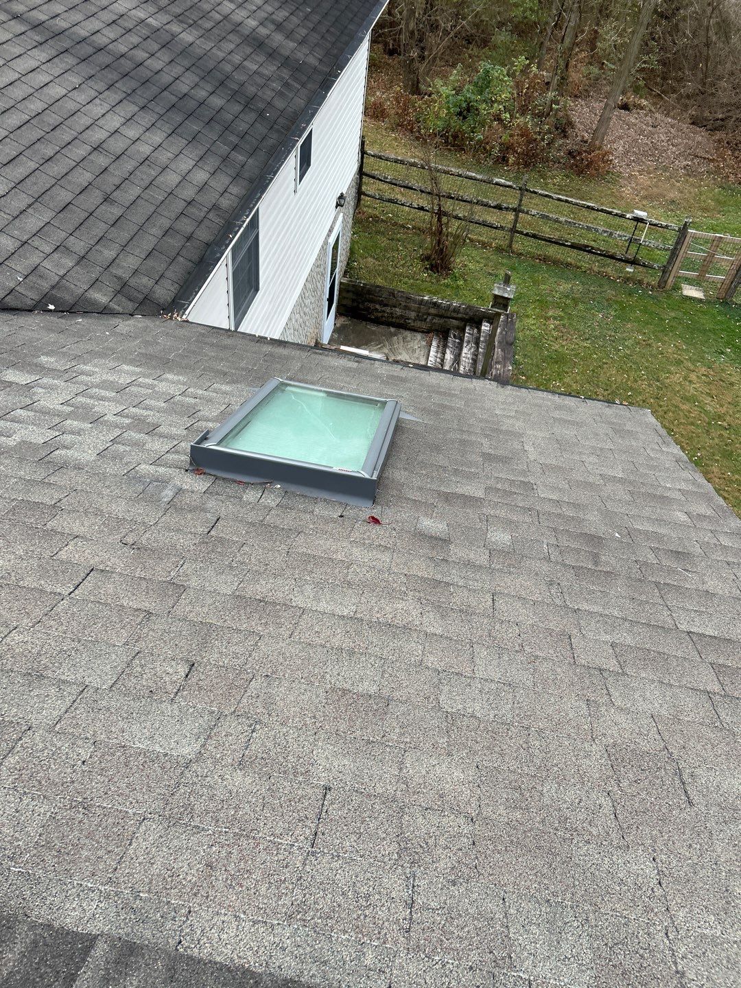 Residential asphalt shingle roof with skylight on Lincoln Road
