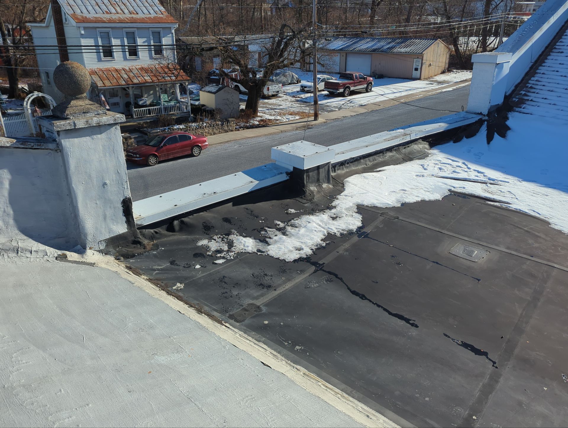 Commercial flat roof replacement with new membrane system and parapet flashing on Main Street in Shoemakersville, PA.