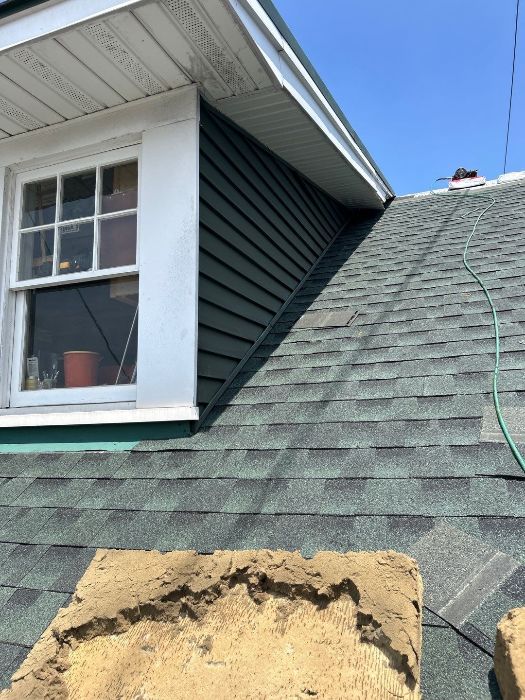 Roof repair around a dormer with new step flashing and architectural shingles on Main Street in Shoemakersville, PA.