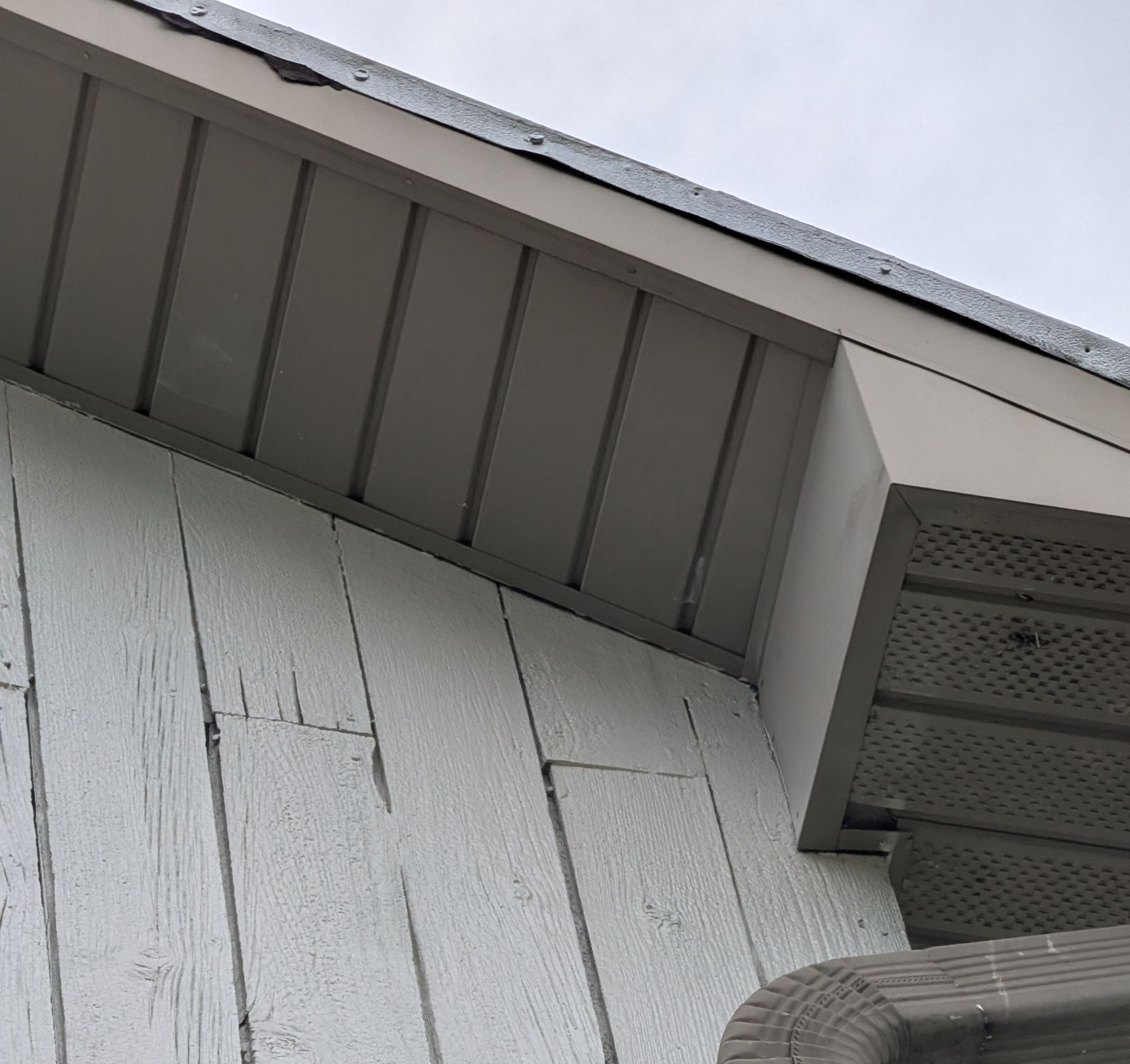 Gutter and downspout repaired along the roof edge of a home on Main Street.