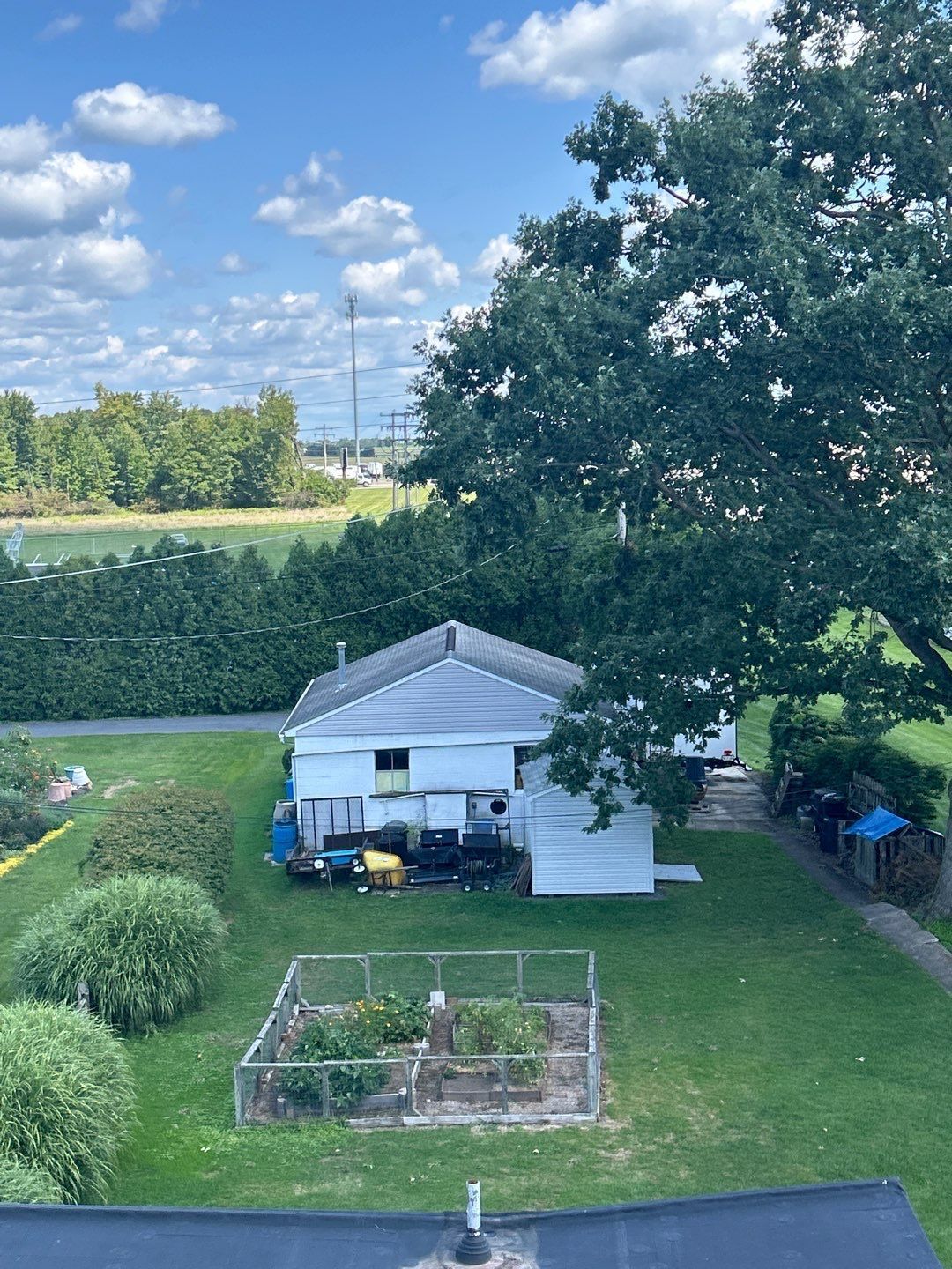 Elevated view from a roof on Main Street in Shoemakersville, PA overlooking nearby property, outbuilding, and surrounding landscape.
