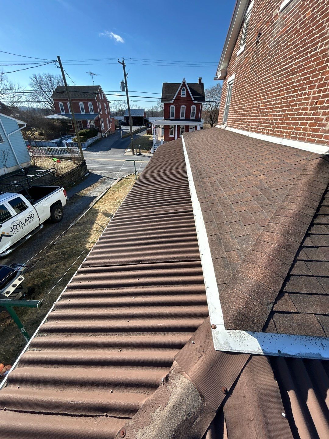 Asphalt shingle and metal roofing system on a property along Main Street in Hamburg, PA.