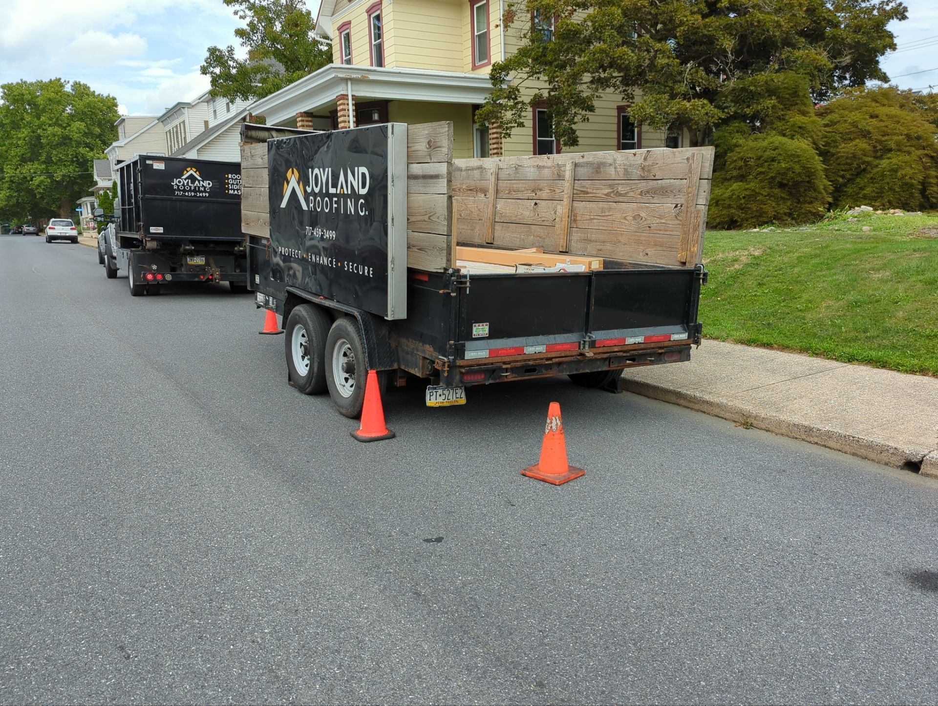 Joyland Roofing trailers positioned outside a home on Main Street in Shoemakersville, PA before a roof replacement project.
