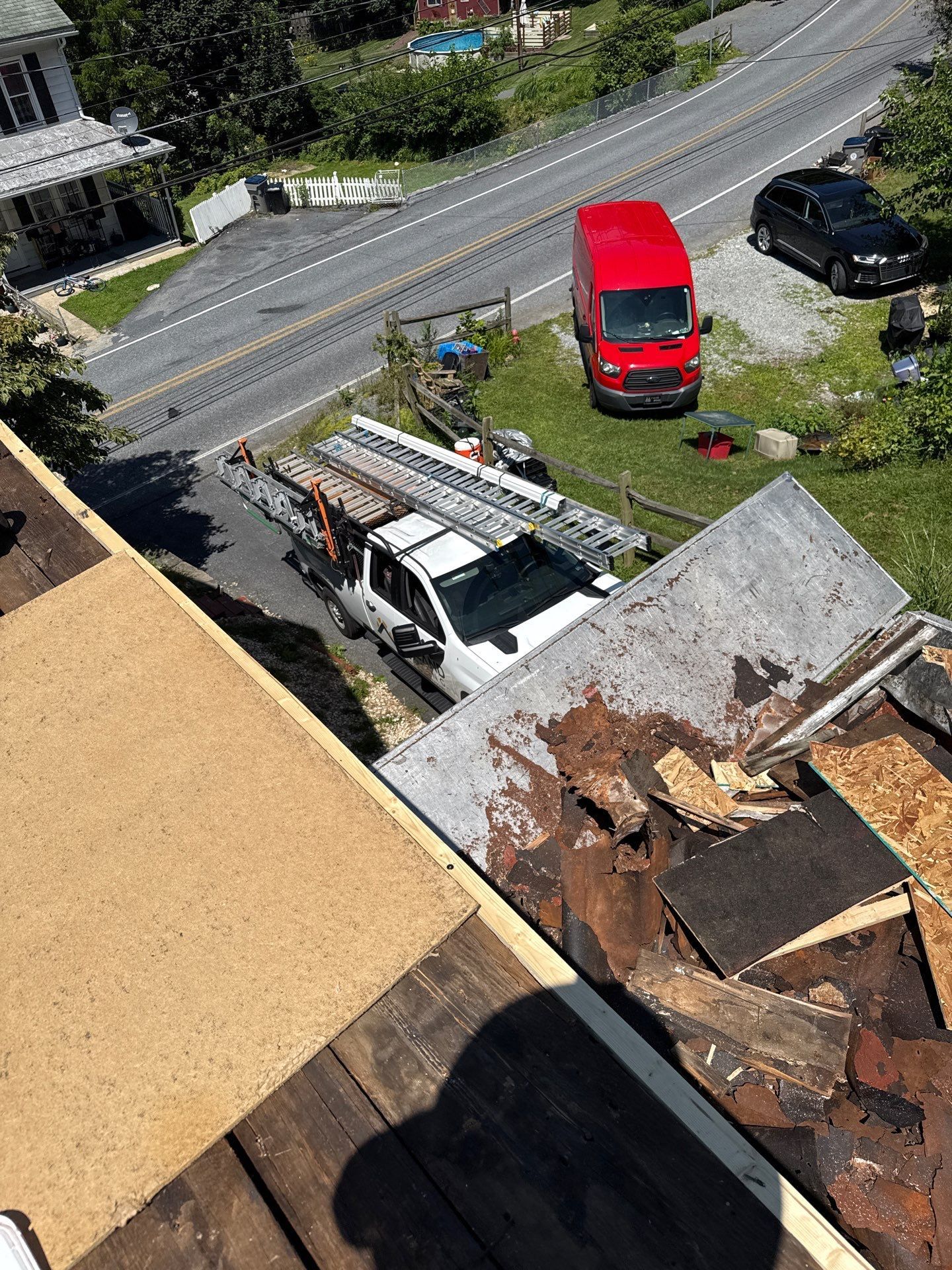 Roof replacement process with old roofing materials removed and new roof deck prepared on North Galen Hall Road by Joyland Roofing.