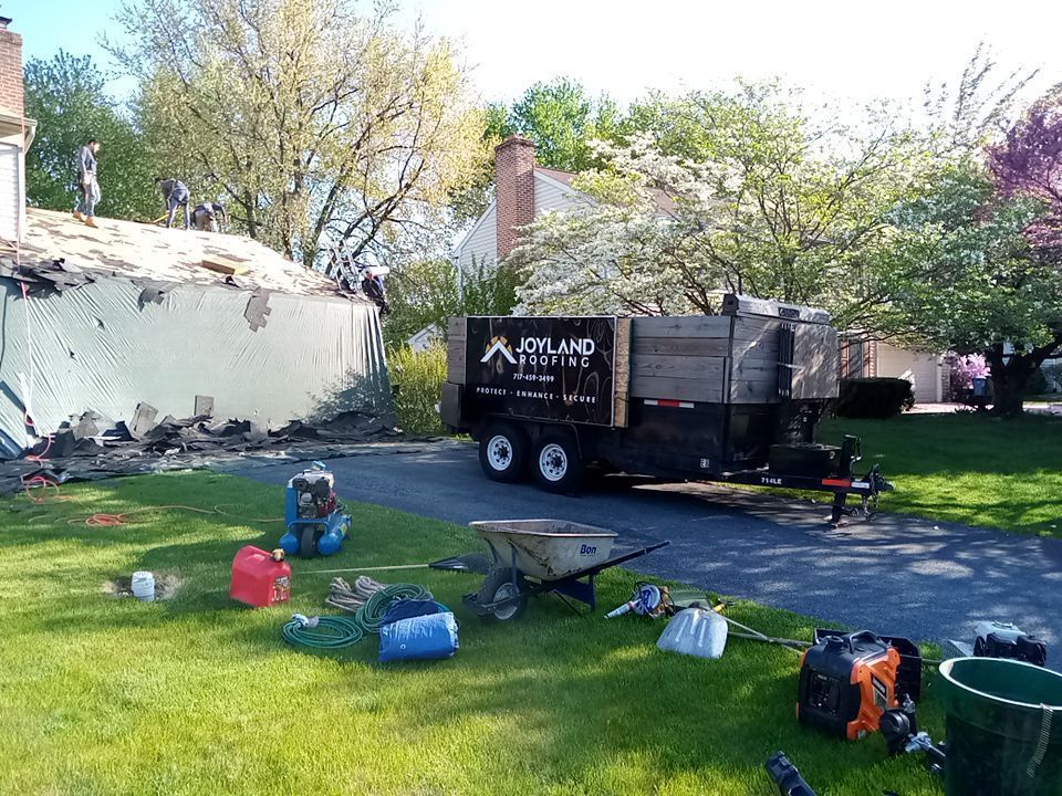Joyland Roofing crew removing an old roof during a roof replacement project on Northridge Drive.