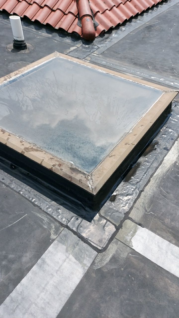 Repaired skylight flashing on a flat roof during a roof repair project on Oley Street in Oley, PA.