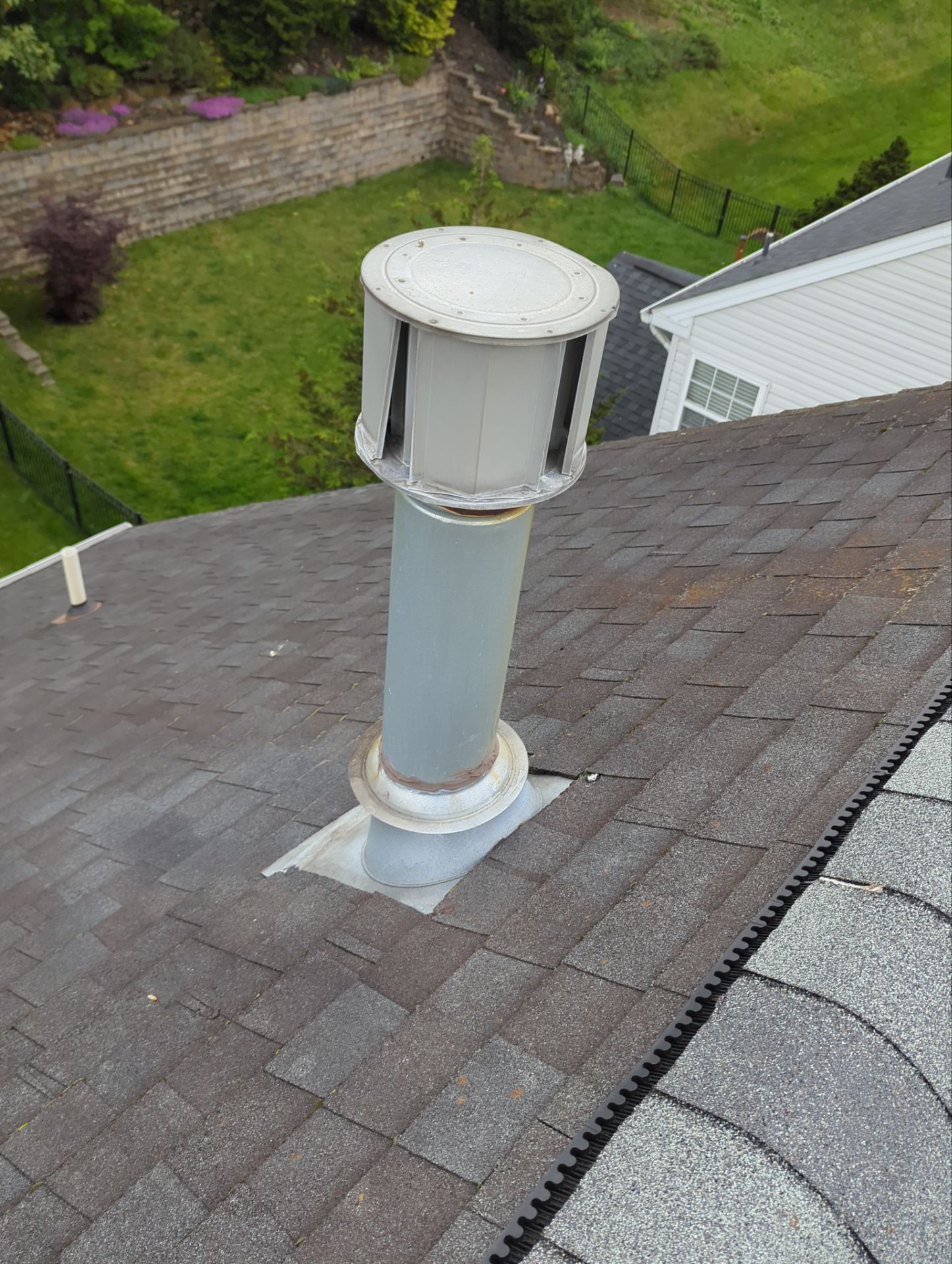 Roof exhaust vent with flashing inspected during an asphalt shingle roof repair project on Oxford Drive in Morgantown, PA.