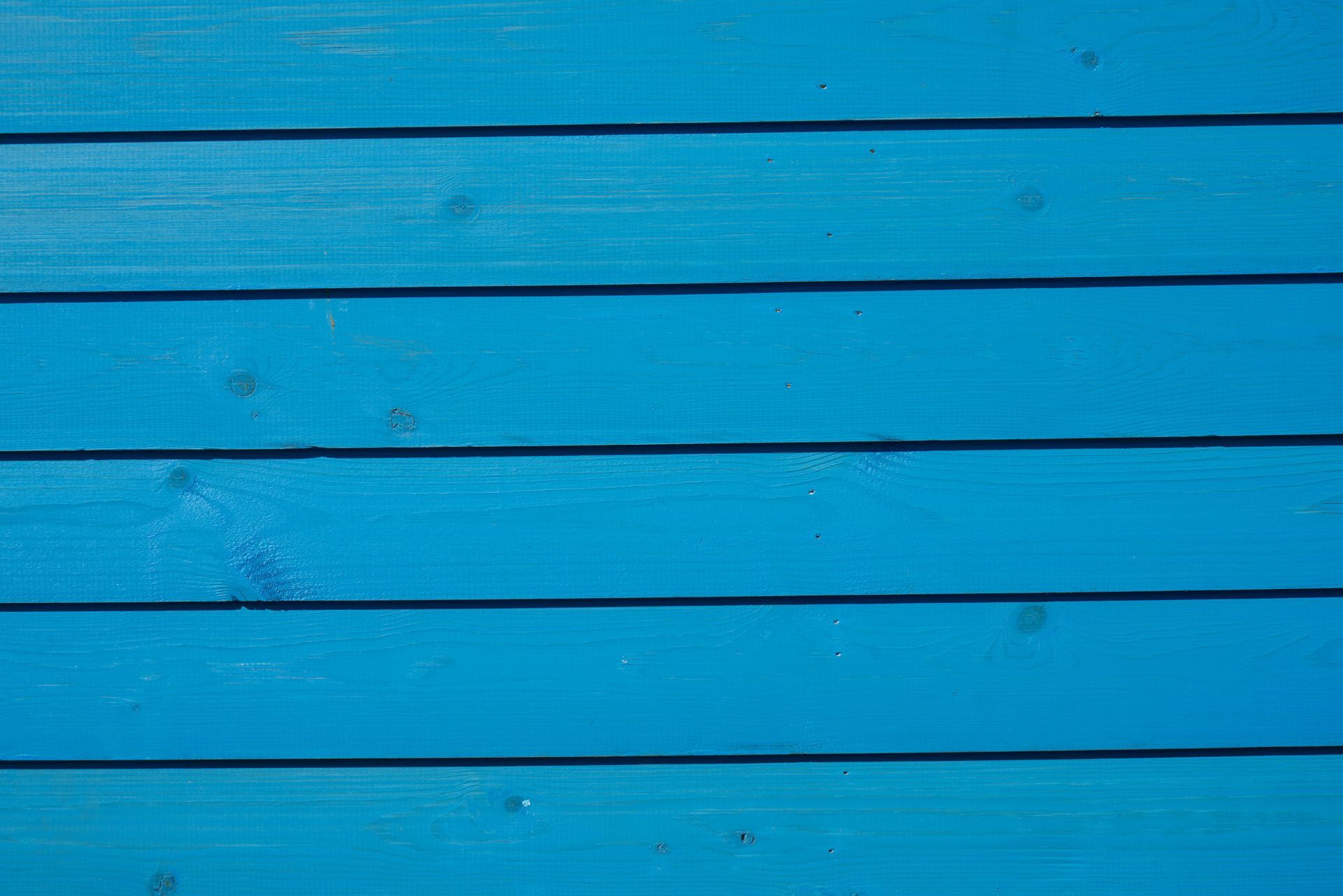 Blue painted wooden planks with horizontal seams