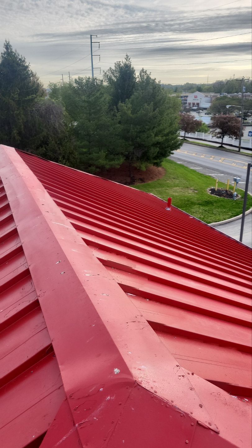 Red metal roof repair on Alan Wood Road in Conshohocken, PA