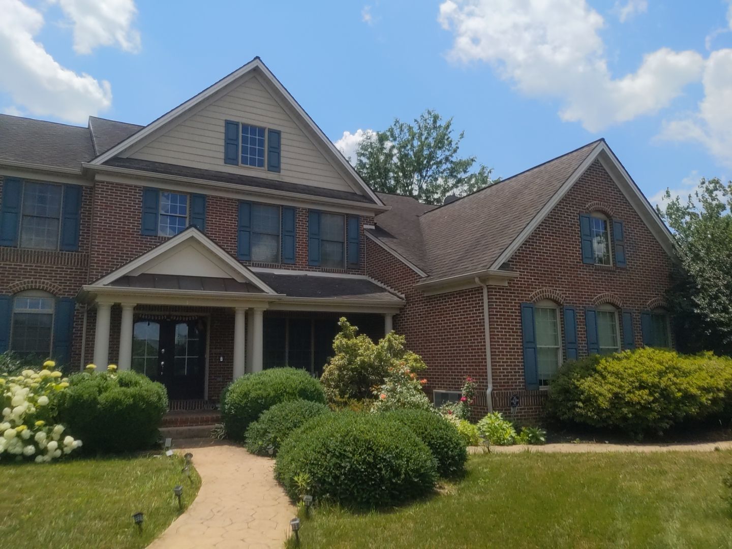 Completed residential roof replacement on a brick home in Fort Washington, PA
