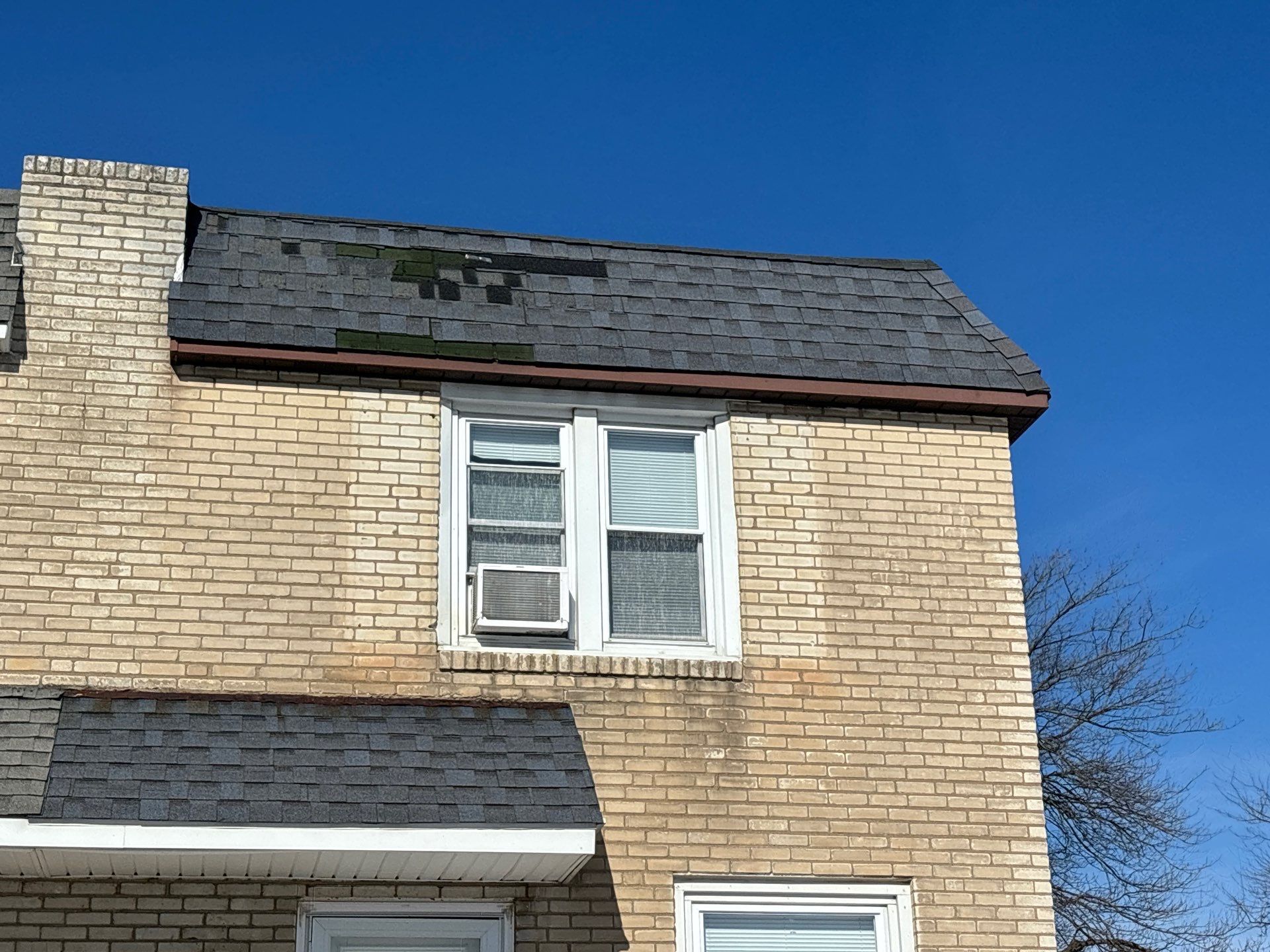 Aging asphalt shingle roof on a brick home along Haller Road in Ridley Park PA