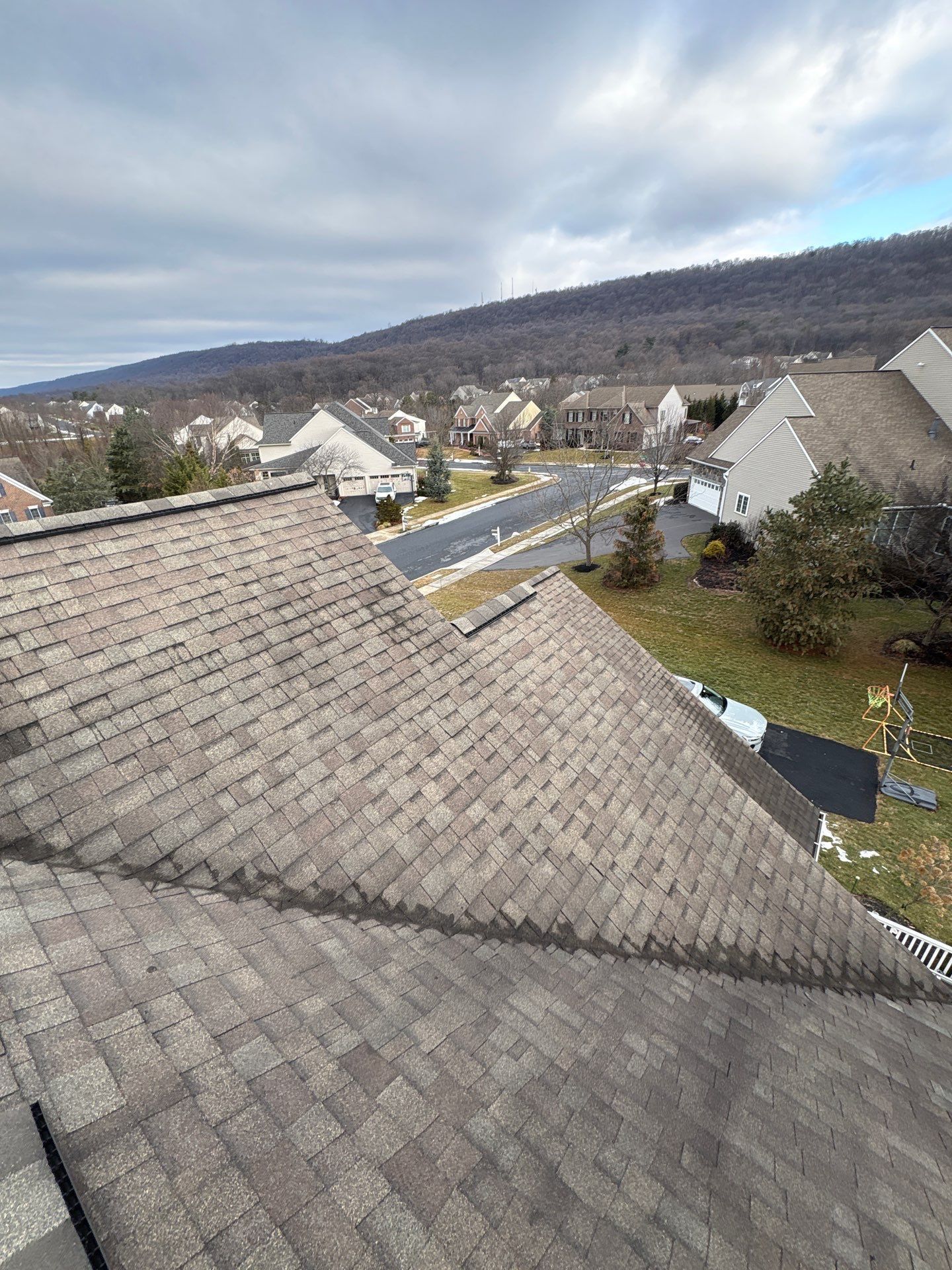Architectural shingle roof inspected during a roof replacement project on Woodstream Way in Enola, PA by Joyland Roofing.