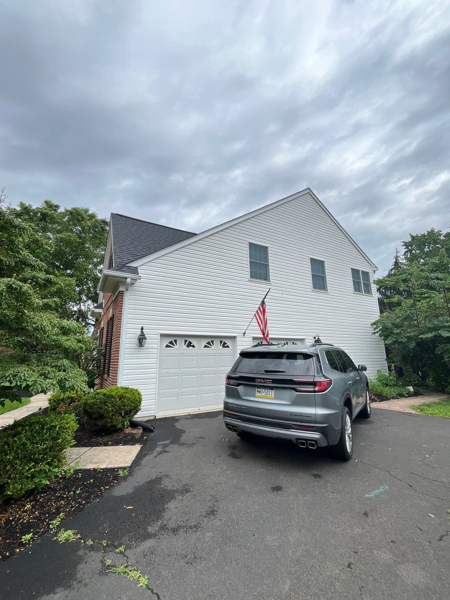 Residential roofing project on Manor Drive in Lansdale, PA showing a finished asphalt shingle roof on a two-story home with attached garage