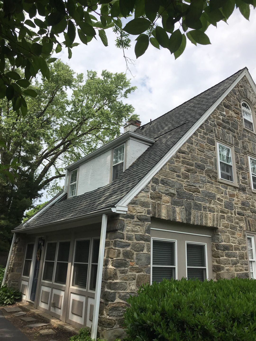 Asphalt shingle roof on a stone home along Valley View Road in Ardmore, PA