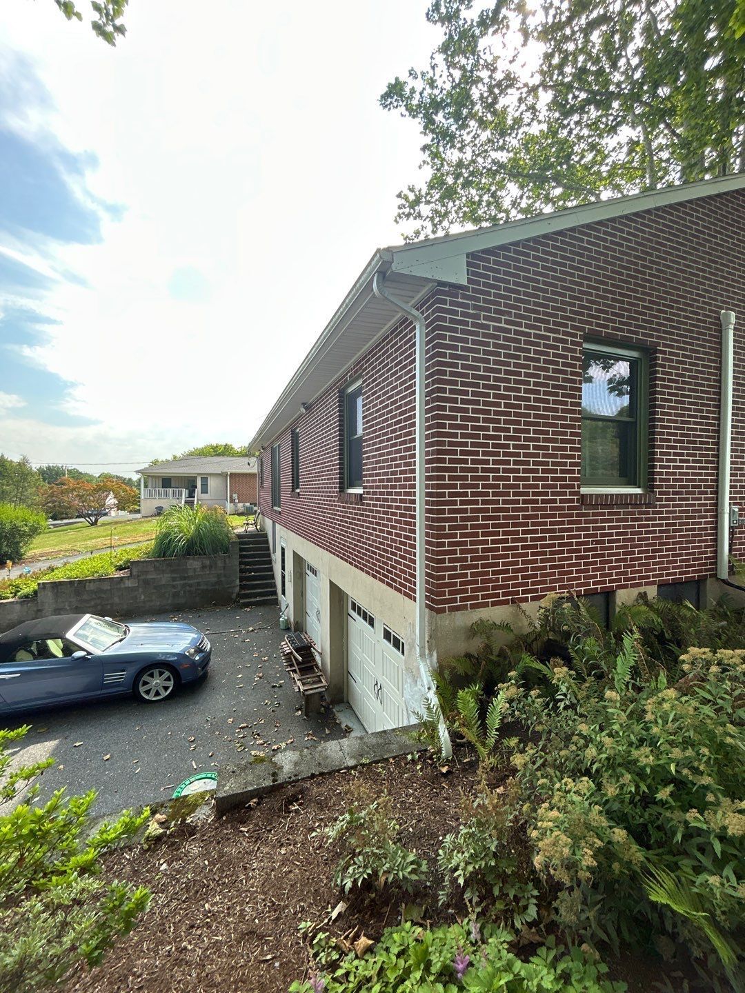 New seamless gutter replacement installed on a brick home along Ridge Road by Joyland Roofing.