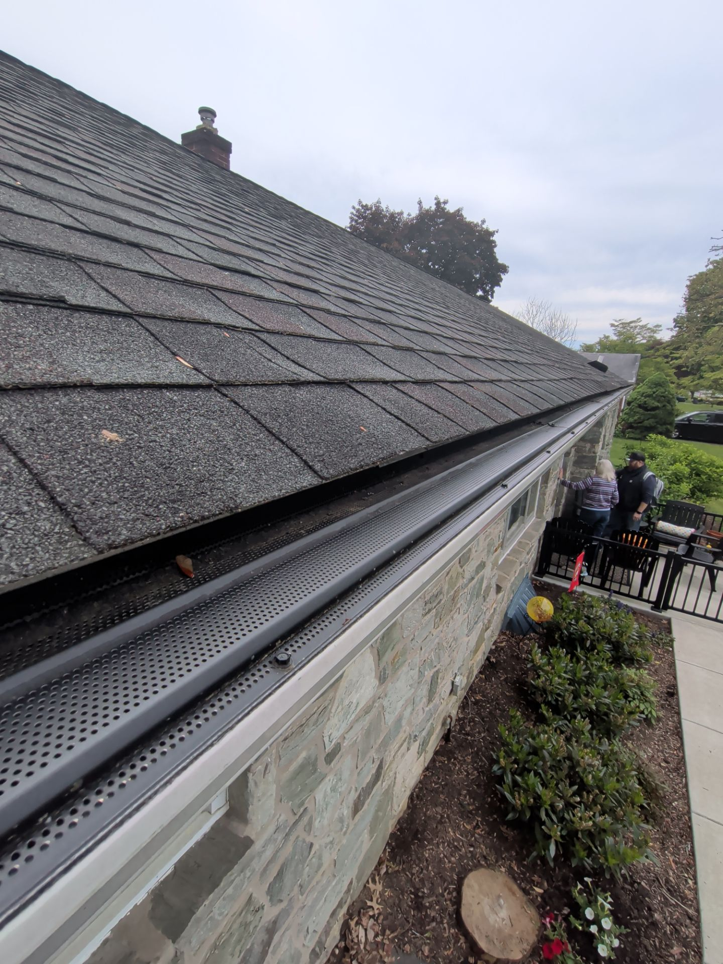 Roof leak and flashing issue near a stone exterior wall on a residential home in Lancaster, PA.