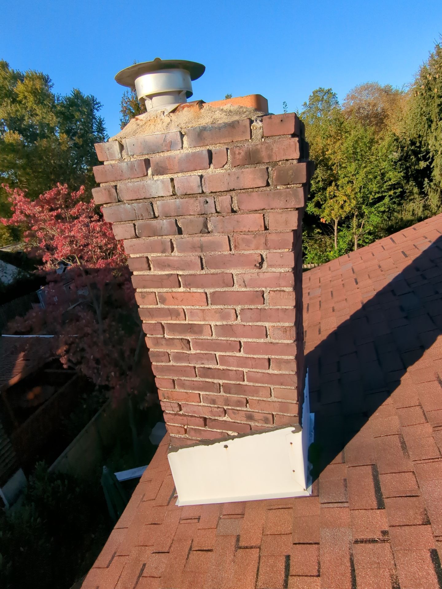 Brick chimney and roof flashing on Dudley Avenue