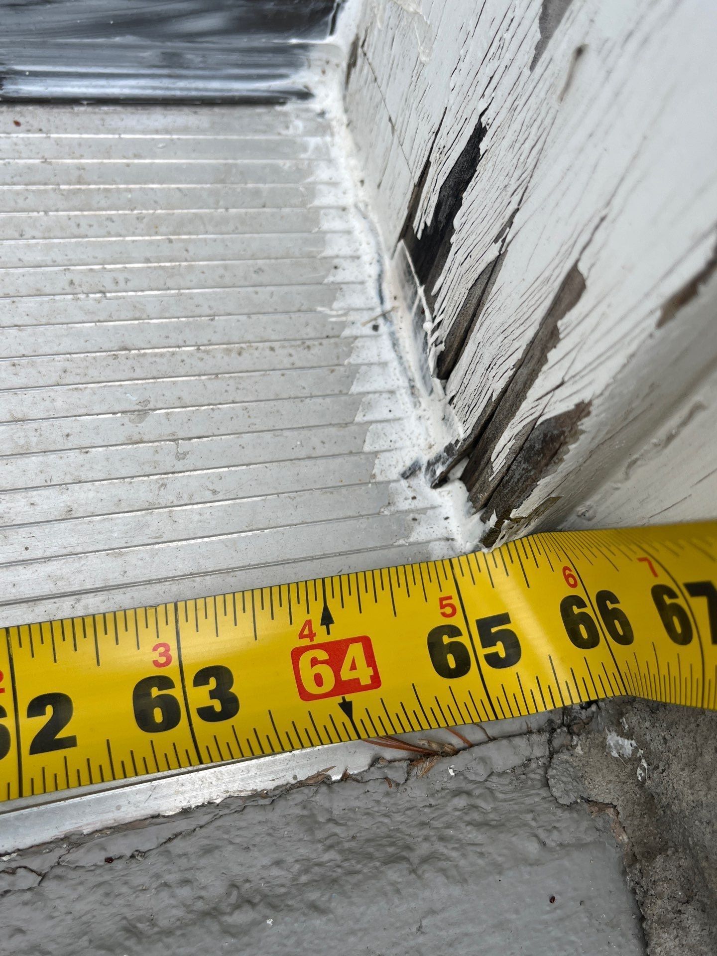 Damaged and deteriorated wood trim along a roof edge on New Church Street in Ambler, PA