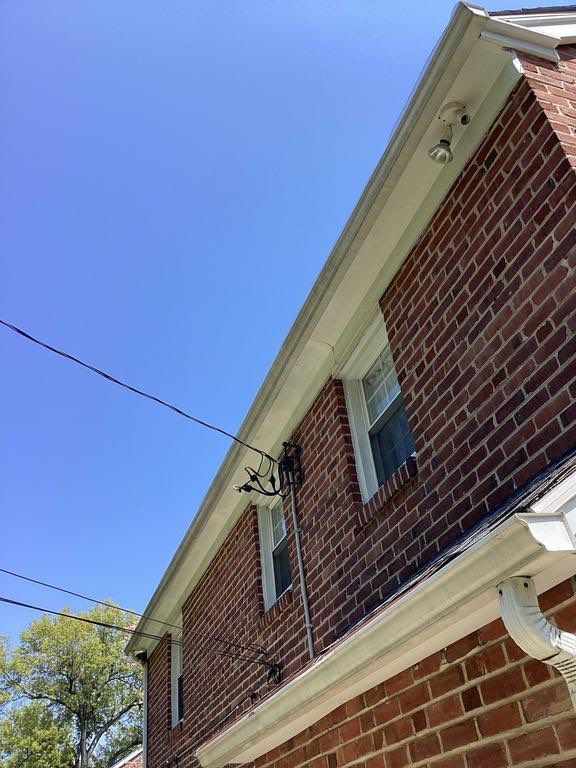 Roofline, gutter, and exterior flashing details on a brick home along West Hathaway Lane in Ardmore, PA