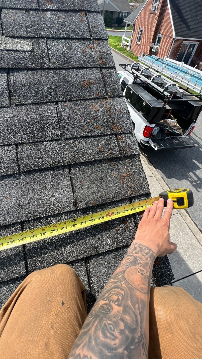 Roof inspection and measurement on Cooper Street in Manchester, PA before a roof replacement by Joyland Roofing.