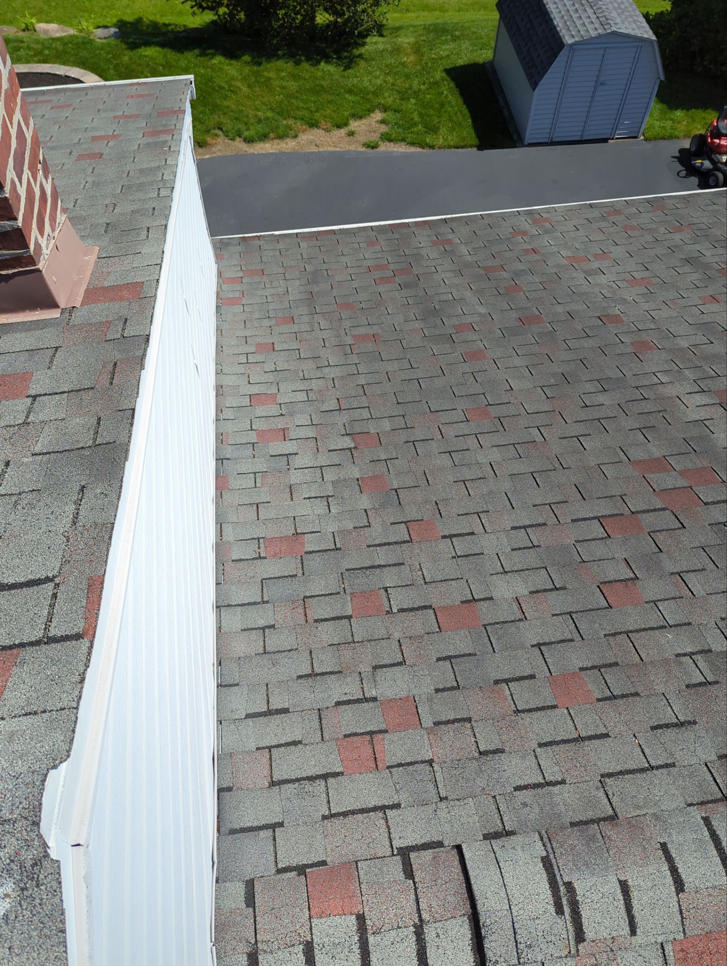 Asphalt shingle roofing installation process with new shingles and roof edge work on Maddock Road in Springfield PA