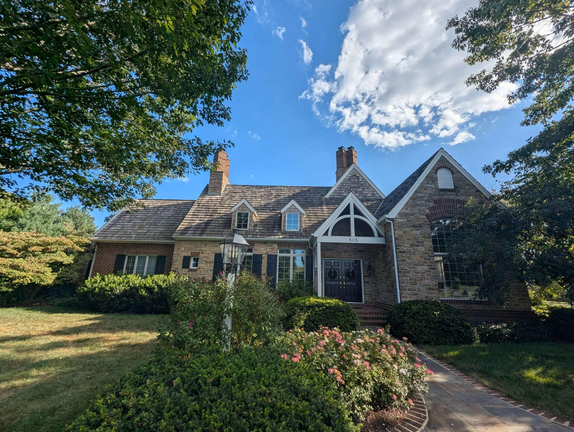 Front view of a home scheduled for a roof replacement on Polo Lane in Wrightsville, PA, featuring an aging cedar shake roof before installation.