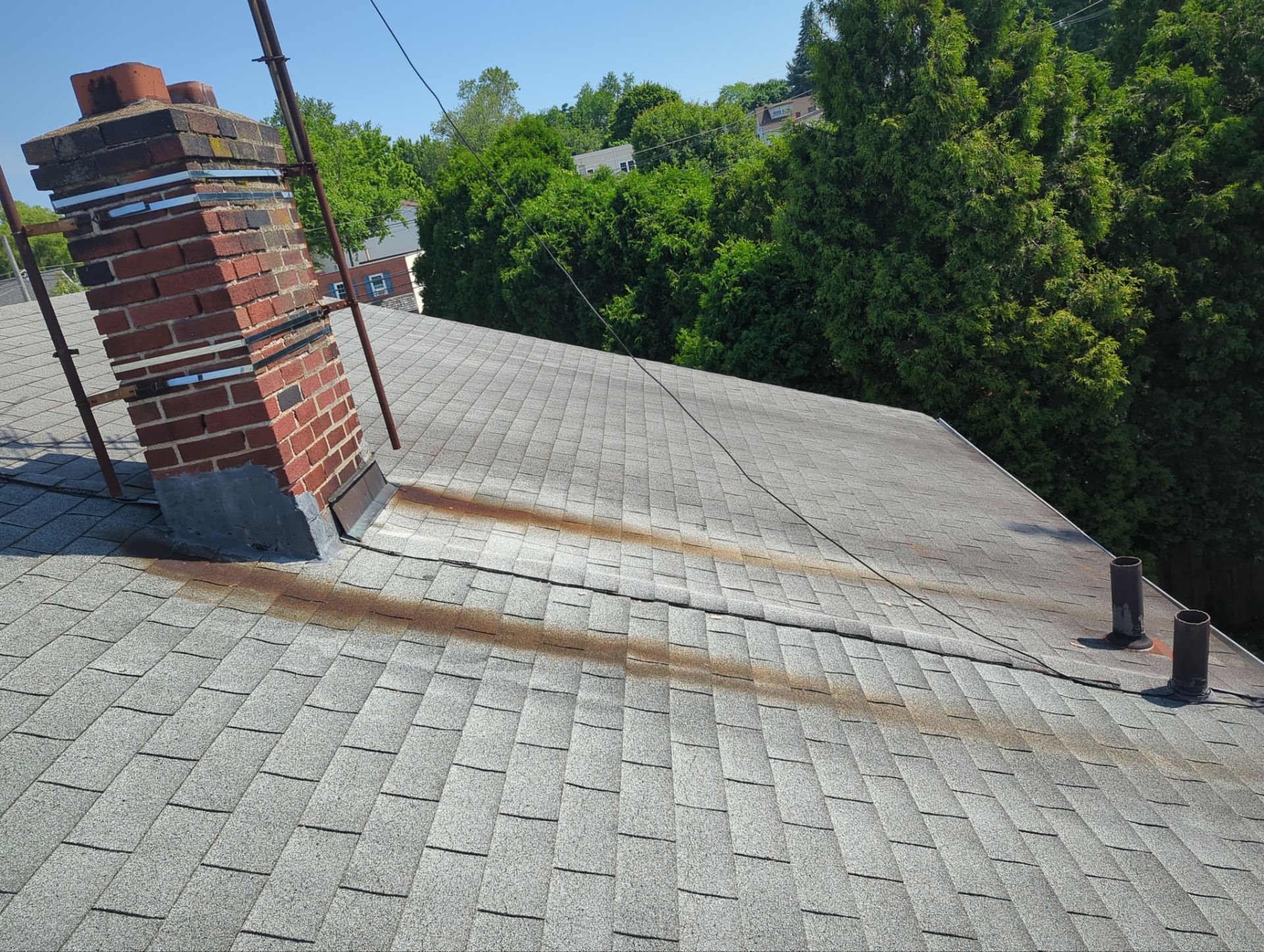 Residential roof repair around chimney flashing on Bailey Road in Bryn Mawr, PA