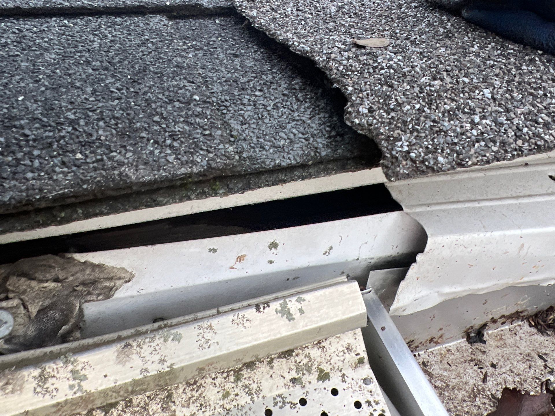 Damaged roof shingles and deteriorated flashing along Walnut Avenue in Ardmore, PA