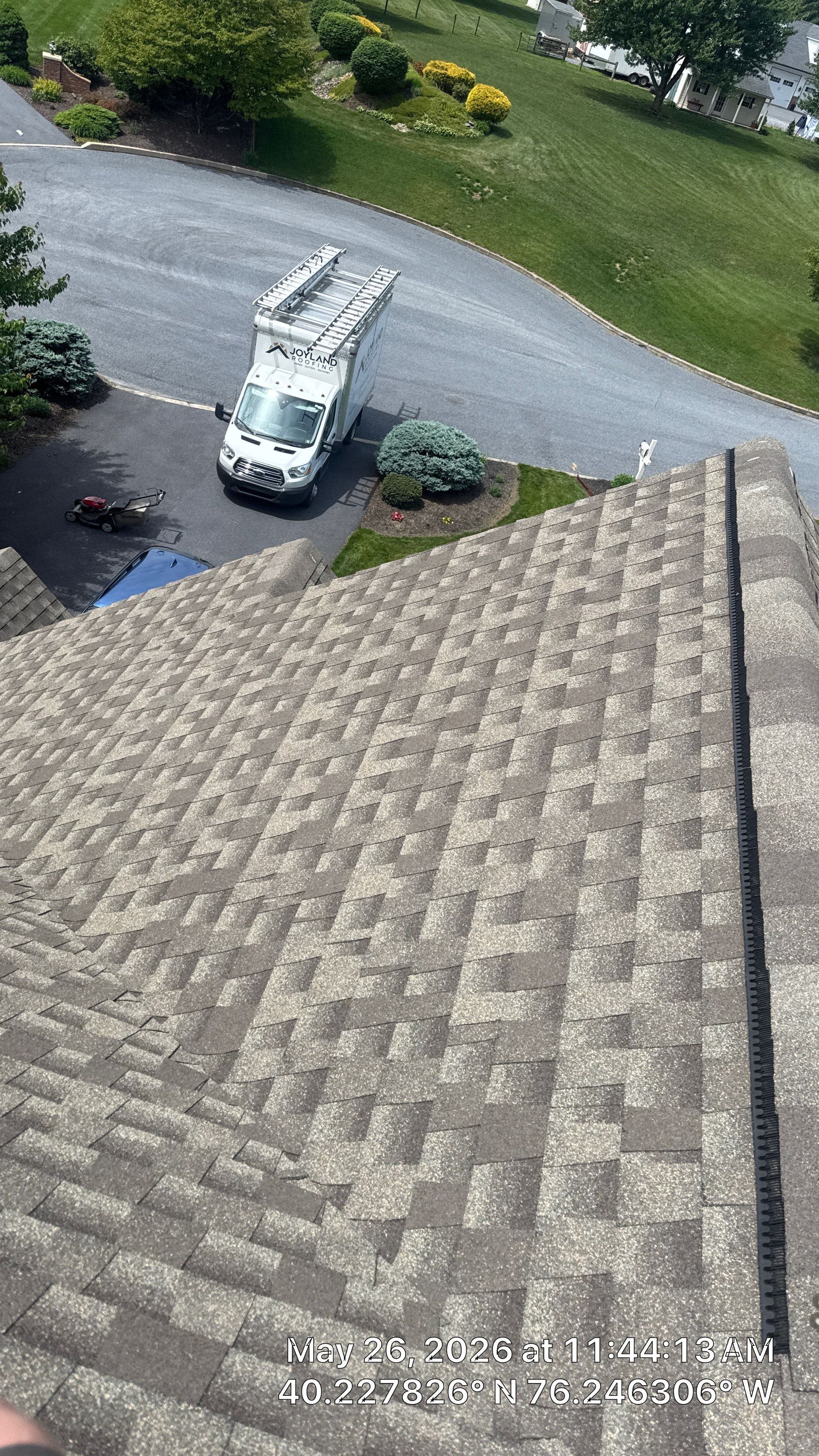 Completed roof repair on Farmland Drive in Ephrata, PA featuring repaired architectural shingles and restored ridge ventilation on a residential roof.