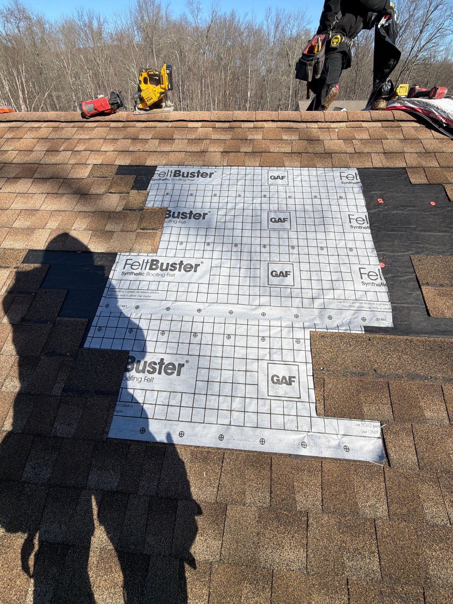 Roof repair in progress on Morari Drive in Dillsburg, PA with damaged shingles removed and new synthetic underlayment installed.