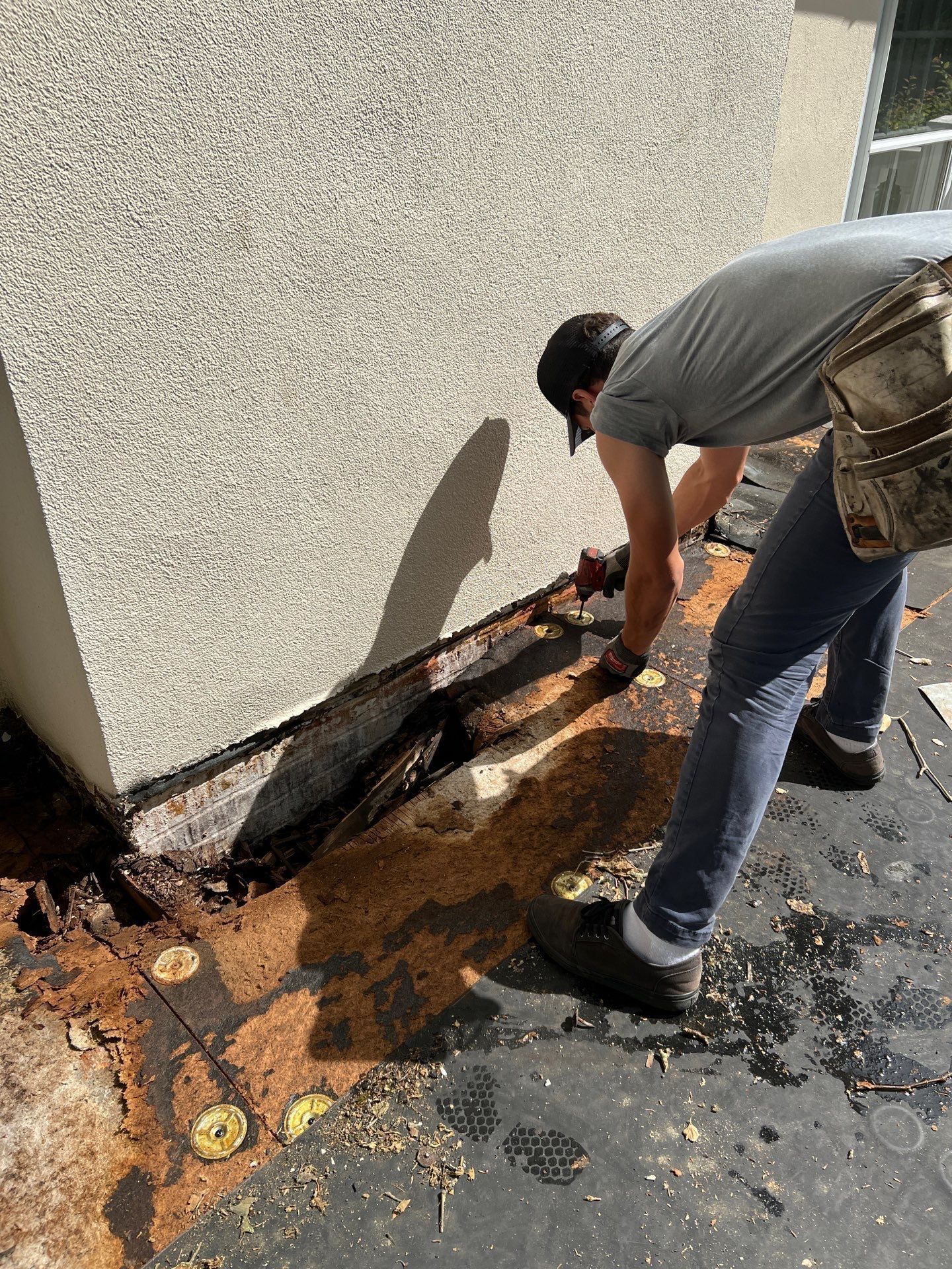 Roofing contractor repairing damaged roof decking on Winsford Road in Bryn Mawr, PA