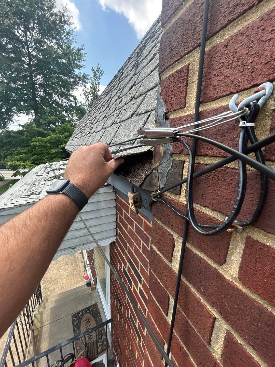 Roof repair and damaged shingles along a brick home on East Roberts Street in Norristown, PA