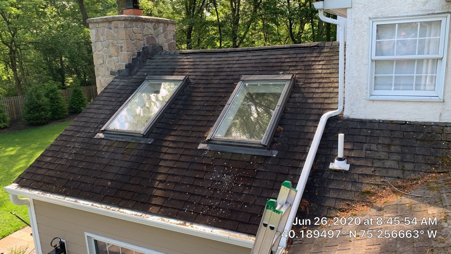 Residential roof repair around skylights and chimney on Gypsy Hill Road in Ambler, PA