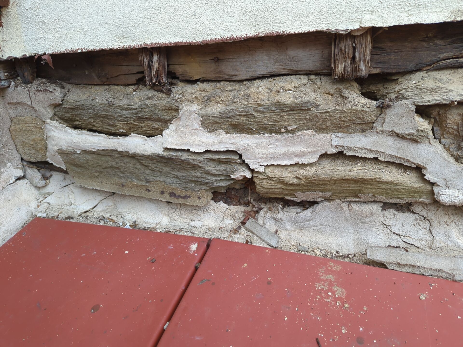 Deteriorated wood and damaged exterior material at a roof and wall transition in Wyncote, PA