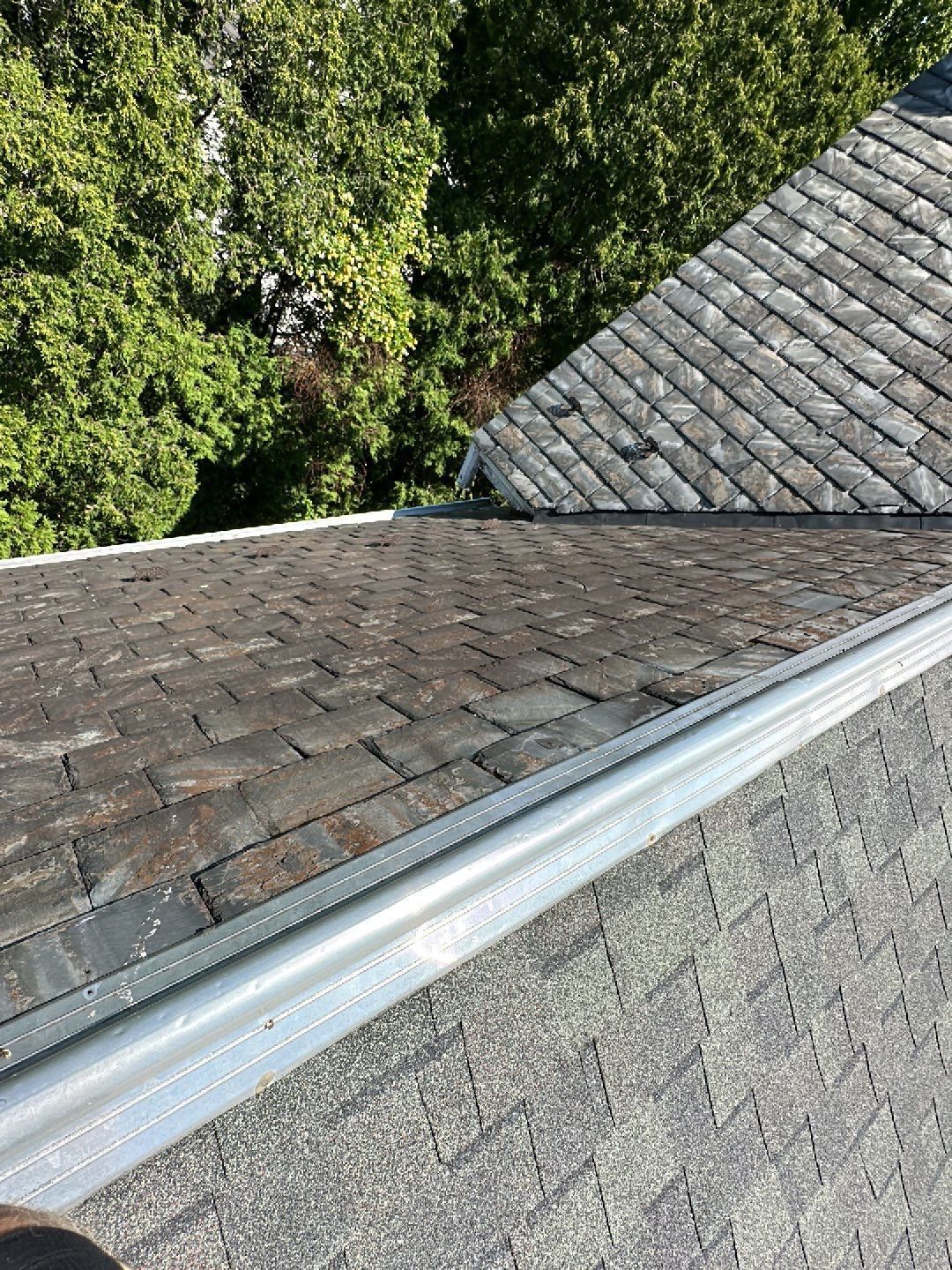 Roof repair addressing worn shingles and a weathered roof intersection in Wyndmoor, PA